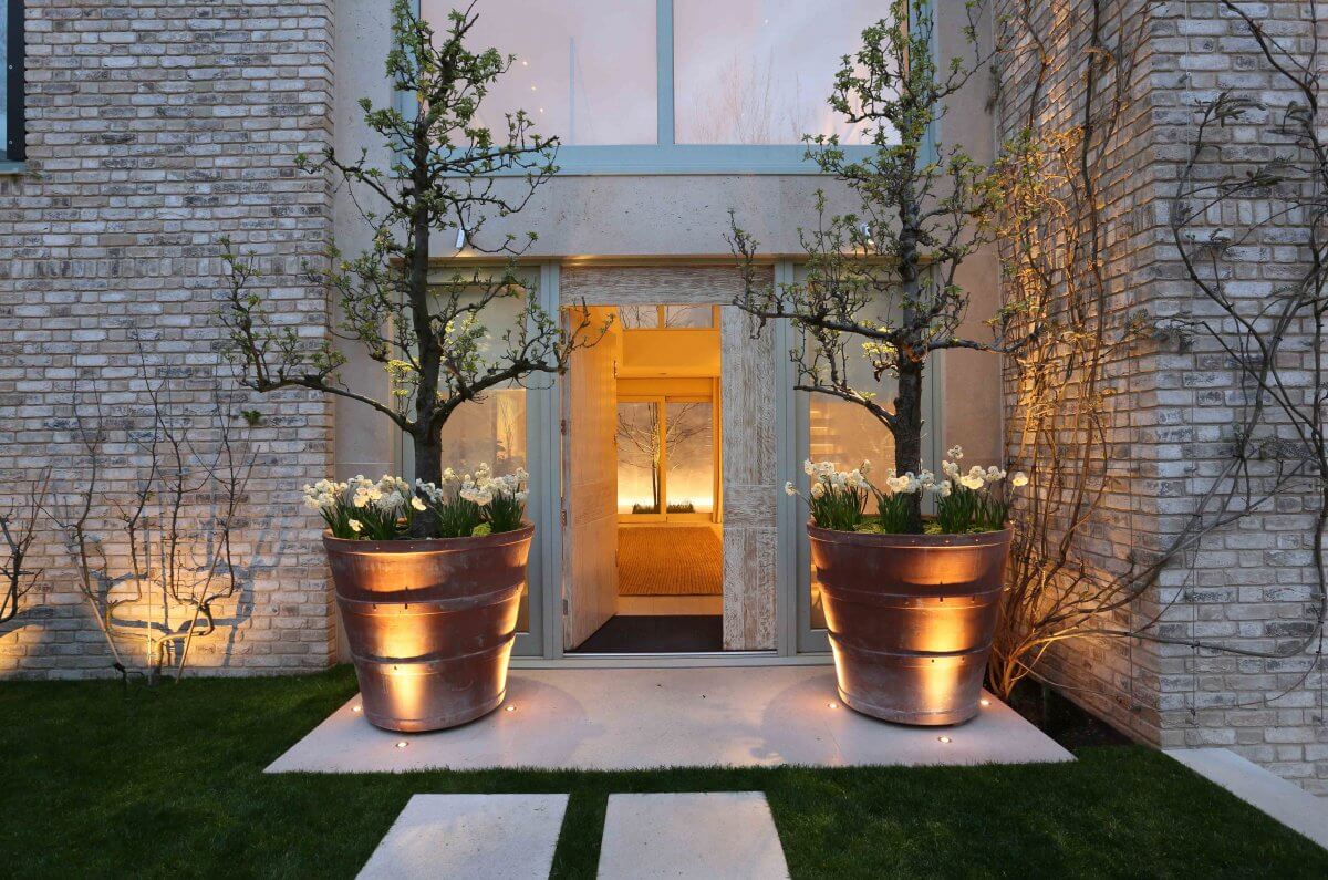 large overscaled pots create a dramatic entrance either side of the front door