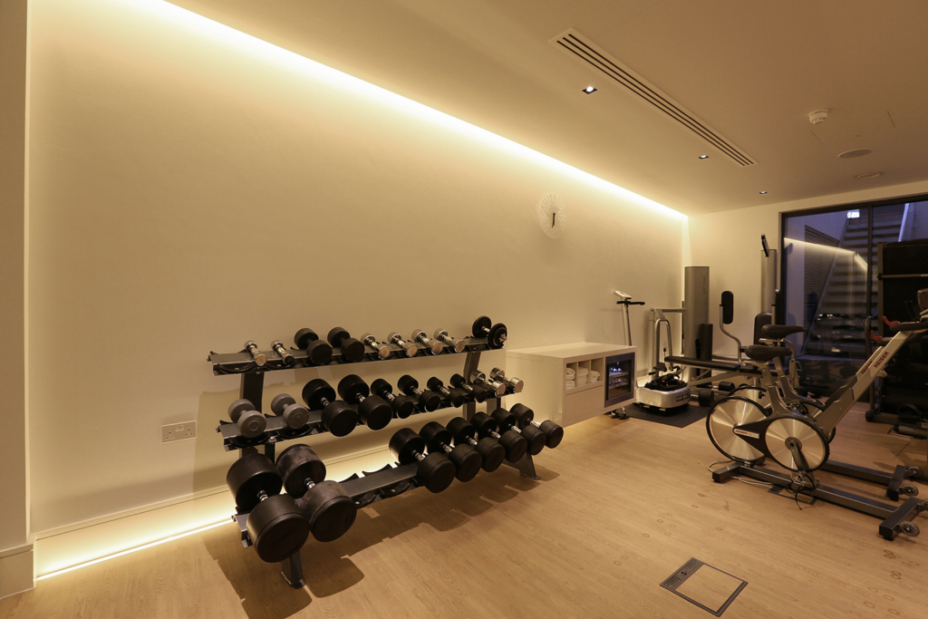 gym with integrated linear lighting in slot