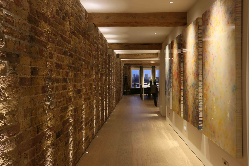 long corridor with up and downlights lit by lighting designer
