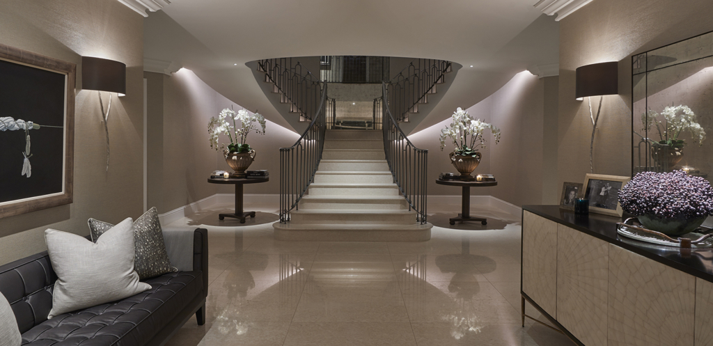 dramatic sweeping staircase underlit with artificial light