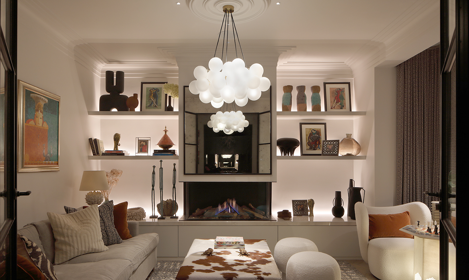 back lit shelving in living room with grand central pendant
