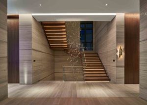 Staircase with lit stairs and decorative hanging pendant