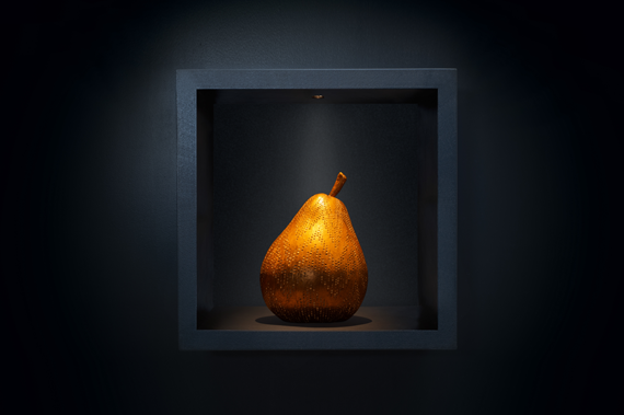 Minim joinery light lighting a pear sculpture in shelving