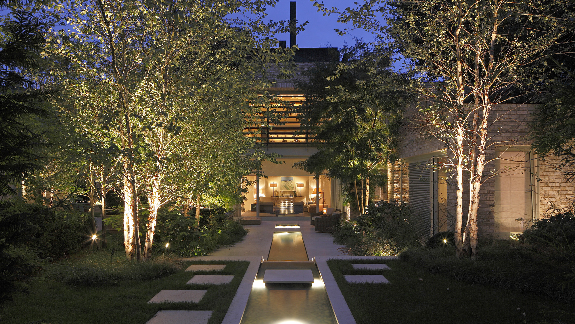 Large garden with view to house beautifully lit