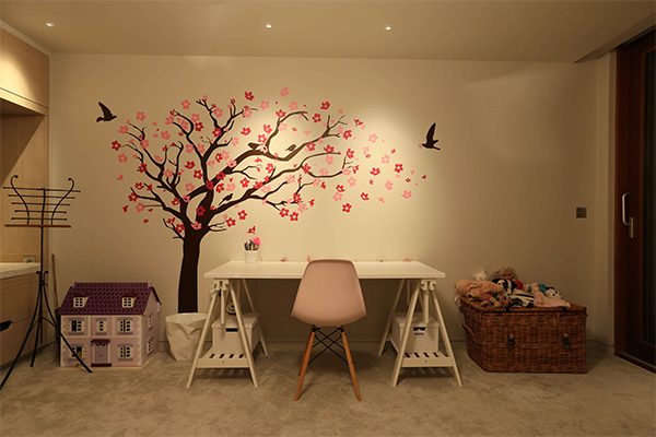 Child's desk in bedroom lit with downlights