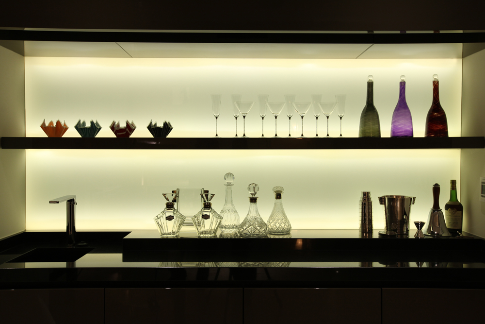 backlit glass bottles in bar