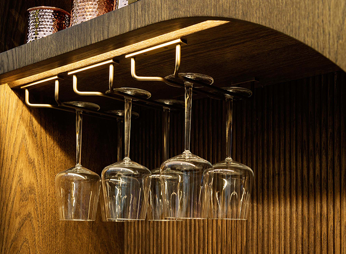 close up of front lighting to hanging glasses in bar