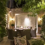 alfresco dining with softly lit surrounding garden