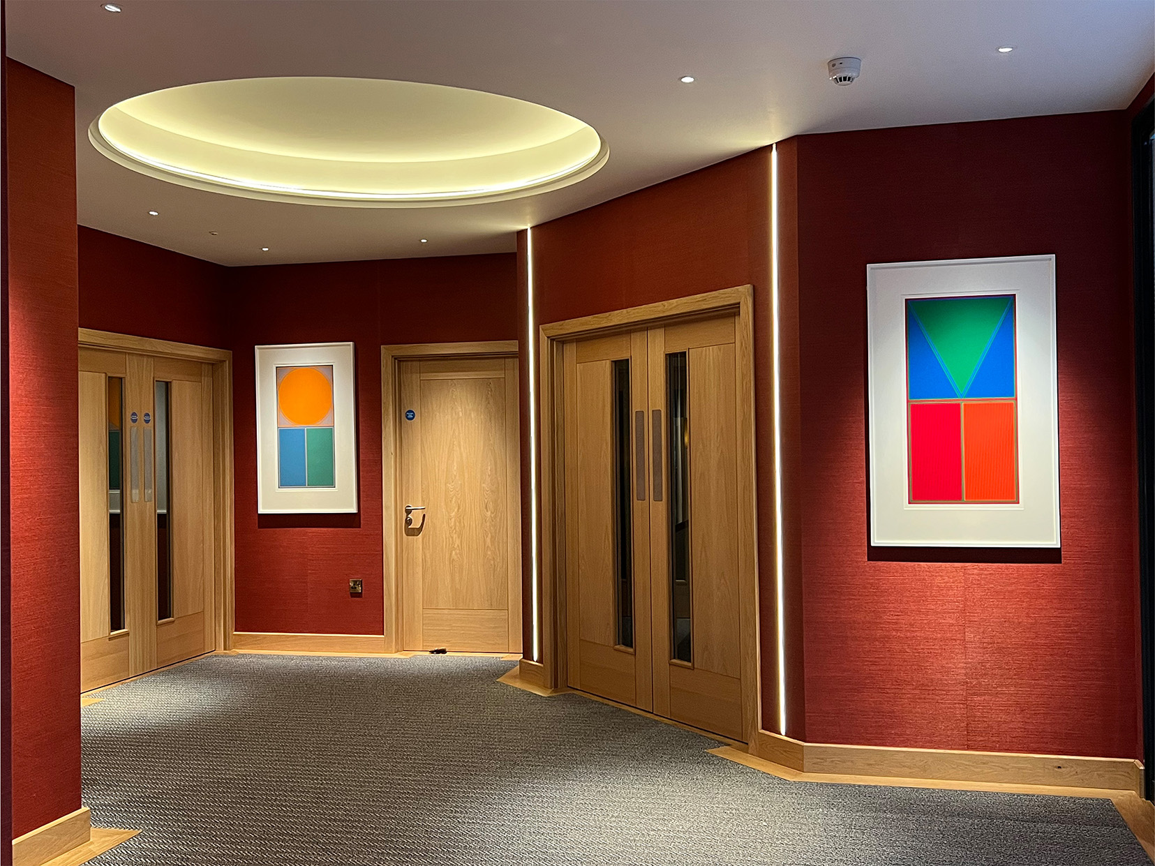 office circulation area with coffer lighting and concealed strips in wall