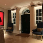 a hall with red art and a layered lighting scheme