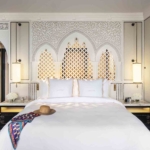 hotel bedroom with decorative pendants and backlit arches