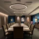 moody lighting in boardroom with circular pendants