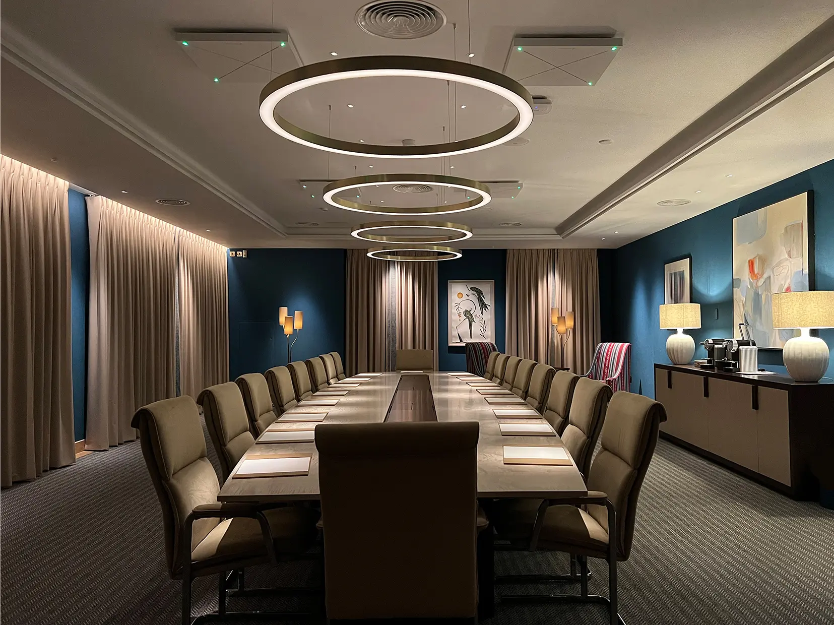 moody lighting in boardroom with circular pendants