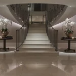 Luxury lighting scheme in dramatic hallway and sweeping staircase