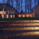 lighitng of curved steps with uplit pots behind