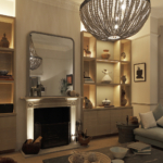 Living room with large pendant and table lights next to lit joinery