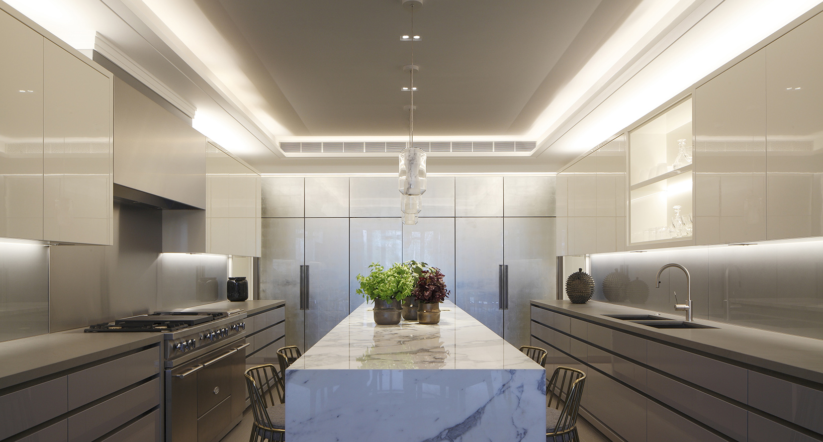 layered kitchen lighting in marble kitchen