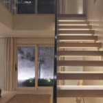 contemporary hall with underlit open stairs and lit courtyard