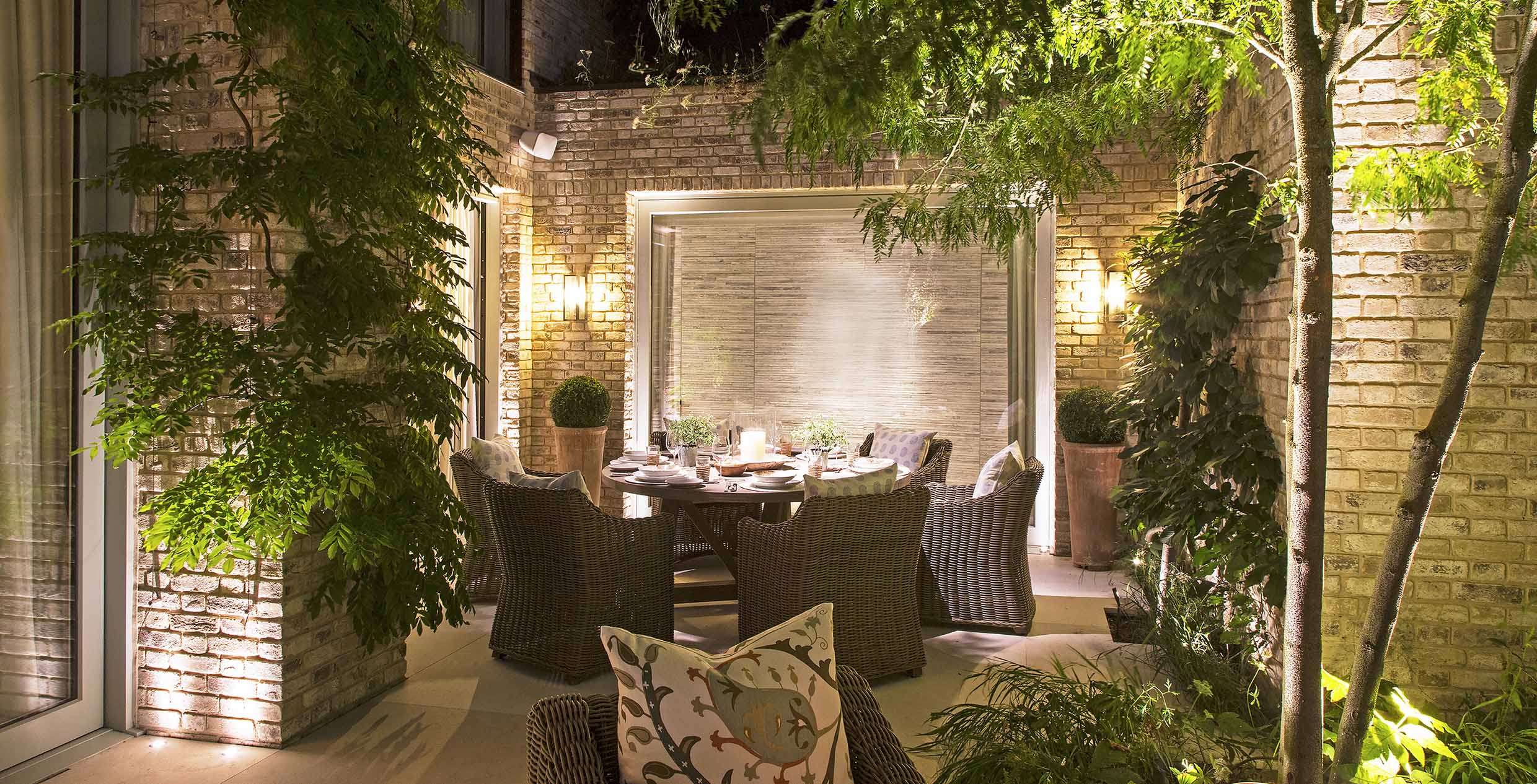 inviting alfresco dining scene with lanterns and uplit structure
