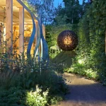 Sculptures surrounded by lit planting