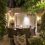 inviting alfresco dining scene with lanterns and uplit structure