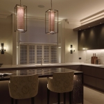 Kitchen with hanging pendants over island and under cupboard lighting