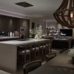 kitchen and seating area with oversized wooden pendants and downlights onto kitchen island, with lit shelves in background