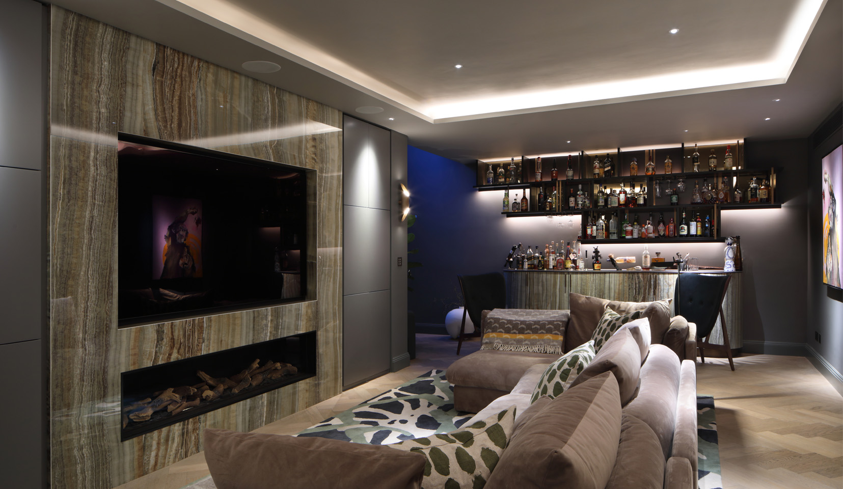 Snug in basement with bar unit and sofa and TV