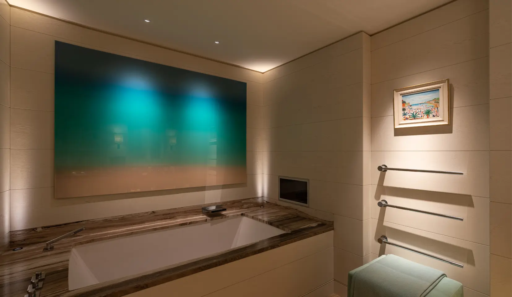 Bathroom with art above bath and directional downlights to light