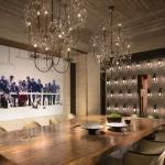 Dining room with chandelier over table and view out into courtyard