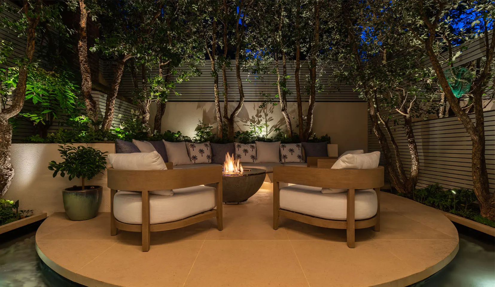 Seating in garden on raised platform with under seating linear light