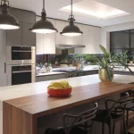 Kitchen with skylight and central island with hanging pendants