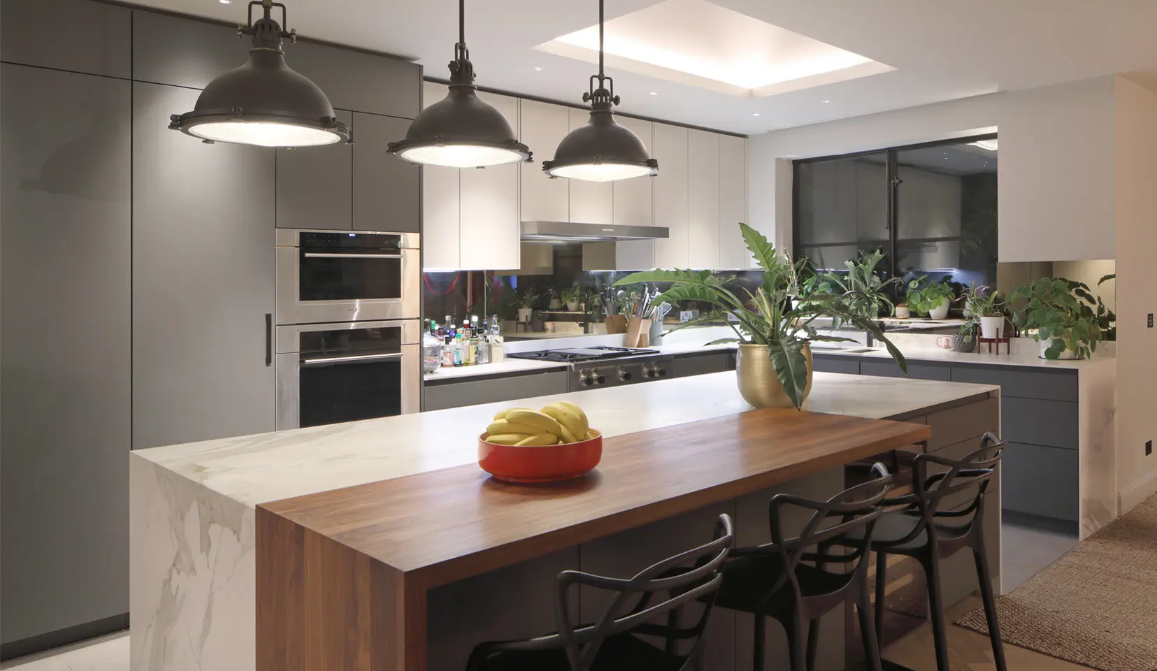 Kitchen with skylight and central island with hanging pendants