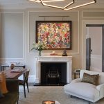 Picture light to artwork above fireplace is luxury living room