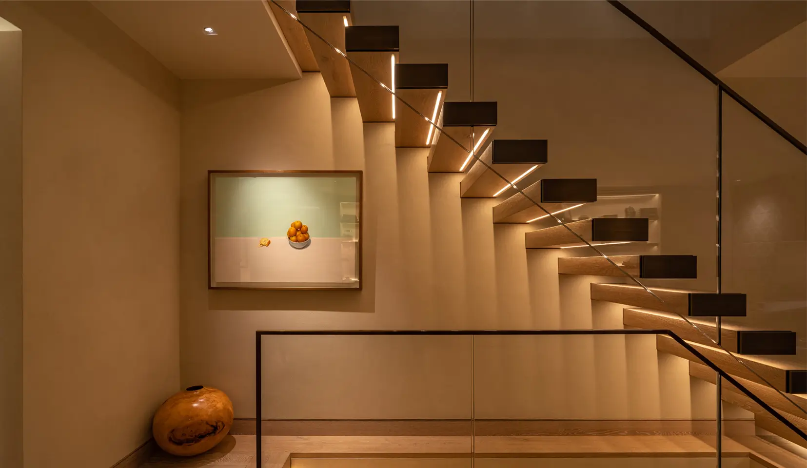 Staircase lit with linear strip under each tread