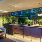 kitchen overlooking garden with living wall and a downlit island