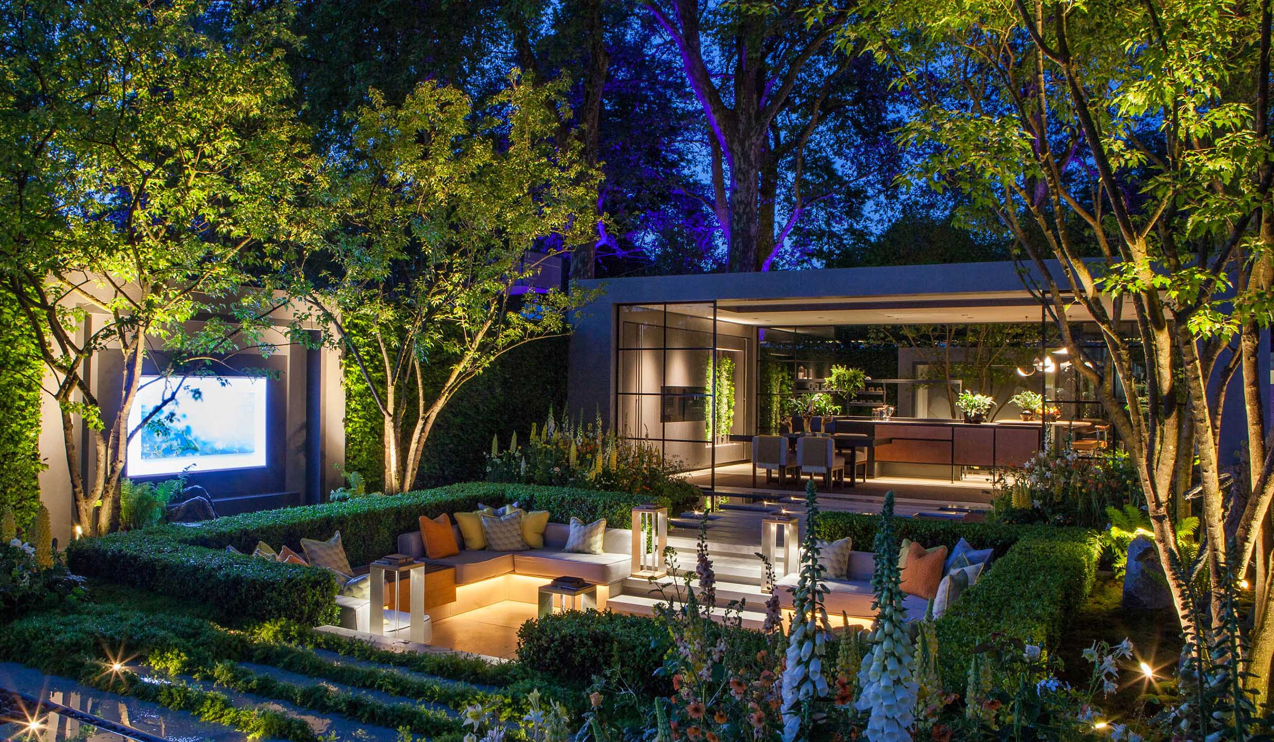 gold winning garden at chelsea flower show with sunken garden, TV screen, kitchen and layered lighting