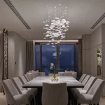 dining area with a decorative chandelier and downlit curtains