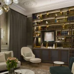 London square house duplex drawing room with large shelving unit and uplit cornicing