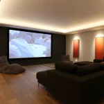 family cinema room with lit art and lighting to floor