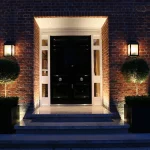symmetrical front door with lanterns and uplights