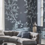 Blue tree print wallpaper in living room with grey sofa