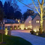 view down drive to large country house with perfect lighting