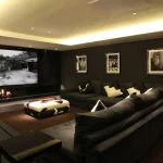 Large home cinema room with coffer ceiling and downlight to coffee table