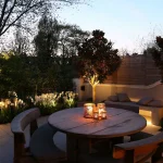 Courtyard garden with table and softly lit tulips