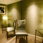 Elegant green dressing room within a clothing store