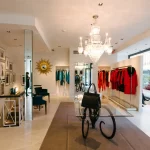 Interior of high end clothing showroom with women's clothing and accessories on display