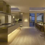 contemporary open plan kitchen and dining with a layered lighting scheme