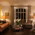 large yellow art lit with vorsa spotlights in living room