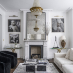 White toned living room with hanging chandelier, sofas and grey rug